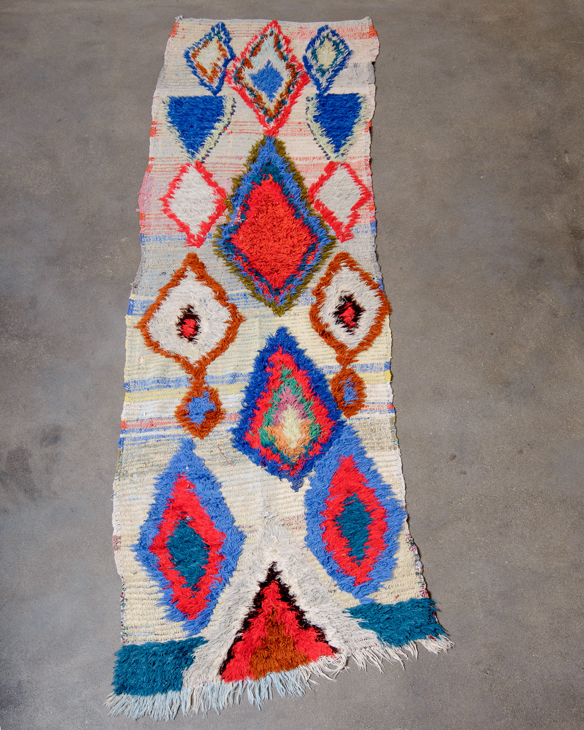 Modern designer vintage handcrafted Berber rug from Morocco. Boucherouite runner rug with beautiful colors and patterns.